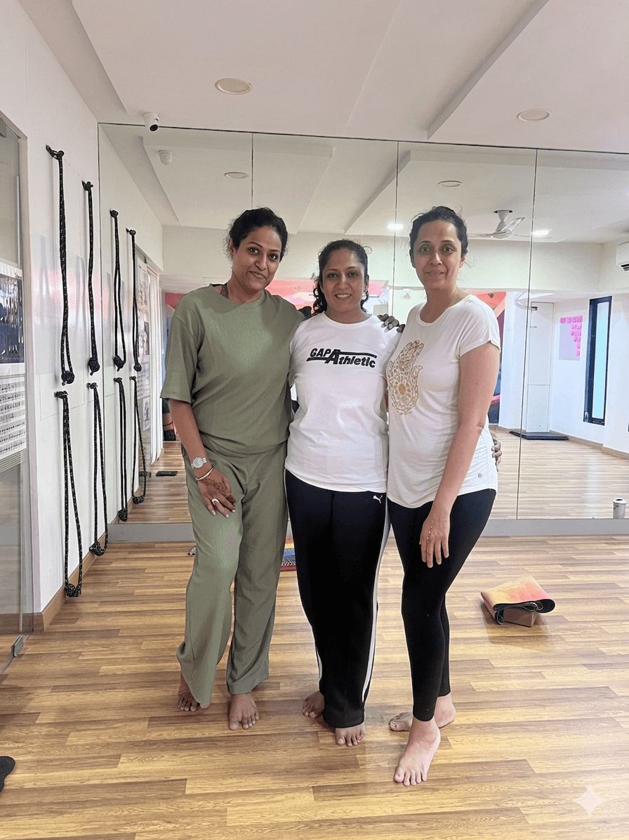 Mayuri standing with two students inside the studio room